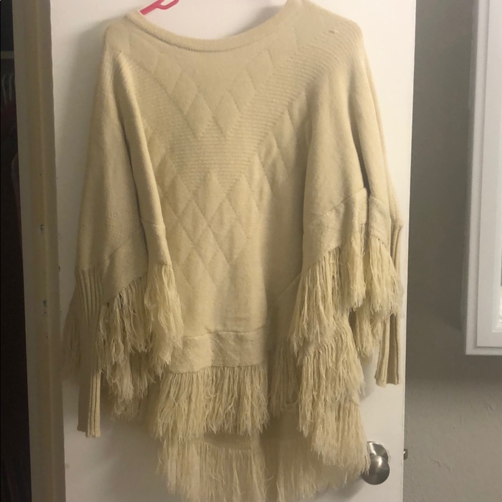 Beige poncho with fringe